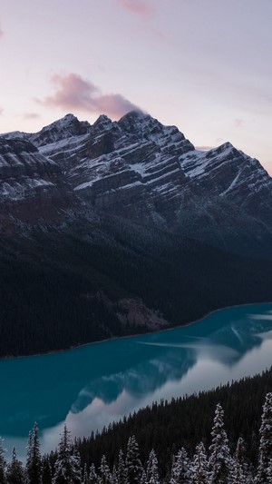 Snow-capped mountains overlooking a turquoise lake