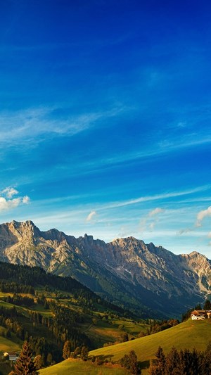 Mountains under a blue sky with clouds