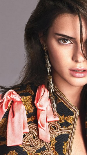 Kendall Jenner wearing an ornate jacket and long earrings