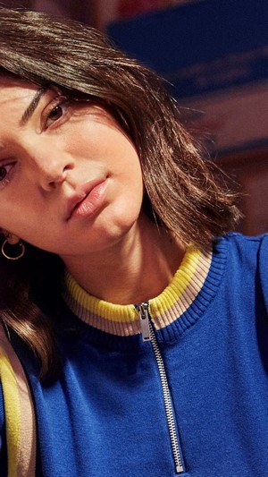 Kendall Jenner wearing a blue zip-up sweater