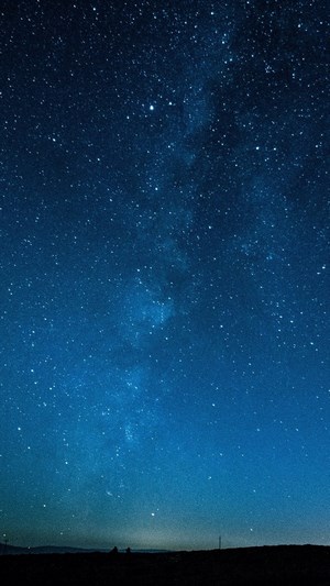 Night sky with stars and the Milky Way over a dark horizon