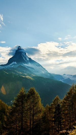 Matterhorn mountain peak with clouds and forest