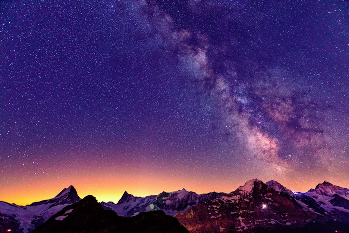 Milky Way over snow-capped mountains in Switzerland
