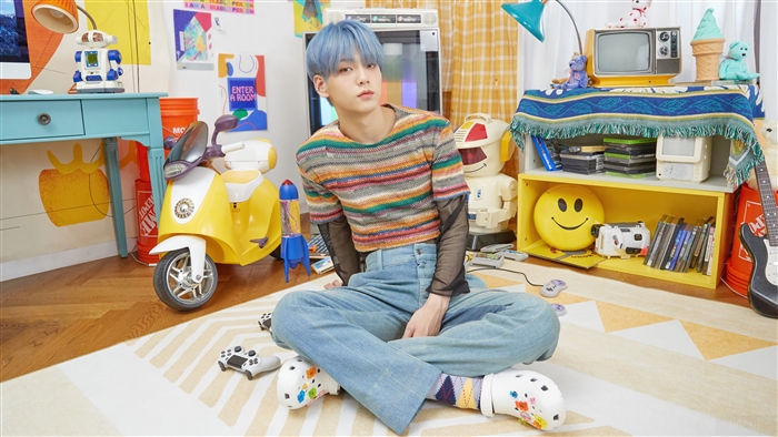 Soobin from TXT in a colorful room
