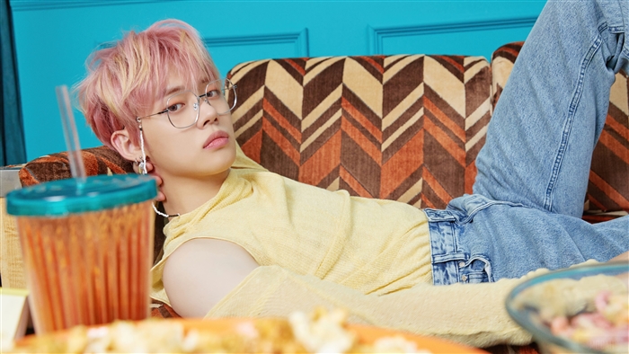 Yeonjun from TXT wearing glasses and yellow top