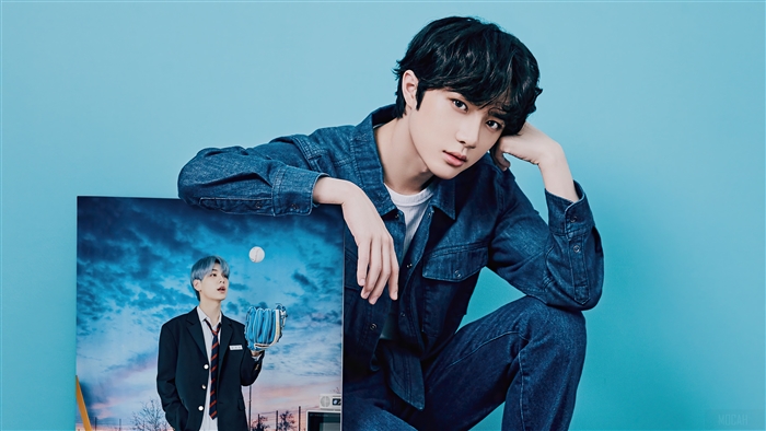Beomgyu from TXT posing with a photo