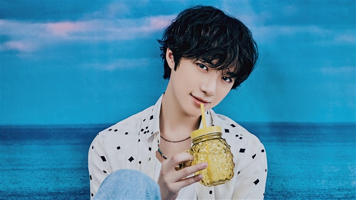 Beomgyu from TXT holding a pineapple cup