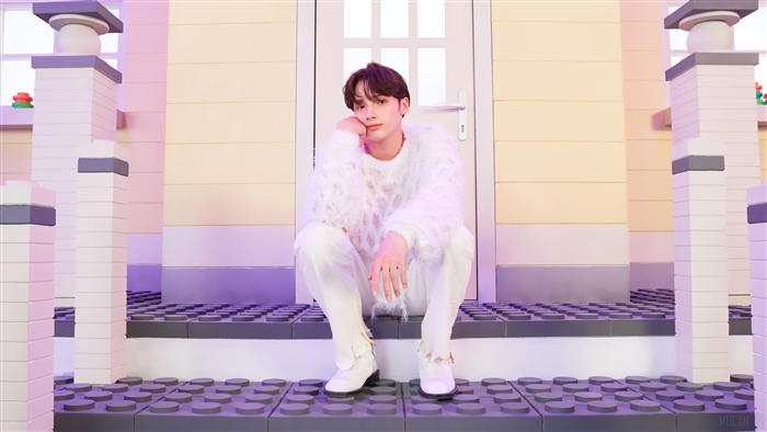 Huening Kai from TXT in a white fluffy sweater