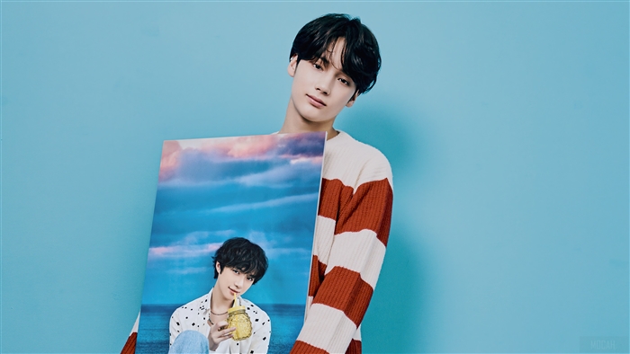 Huening Kai from TXT holding a photo