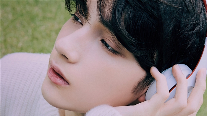 Huening Kai from TXT wearing headphones