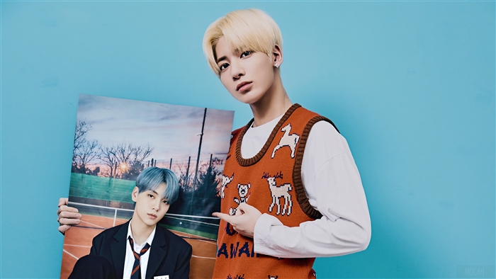 Taehyun and Soobin from TXT holding a photo