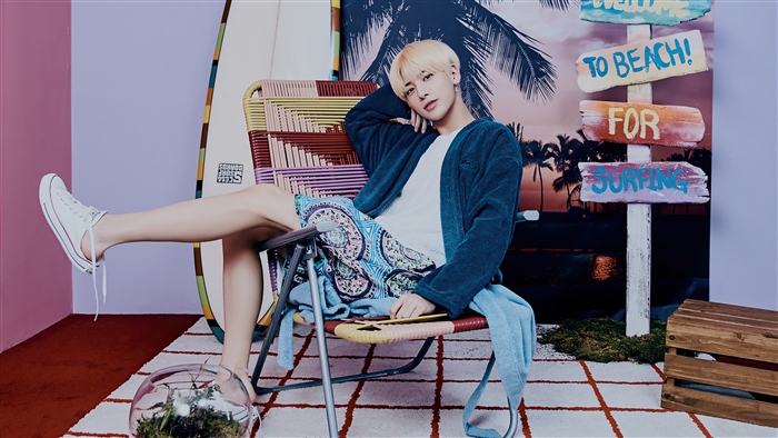 Taehyun from TXT posing in a beach-themed photoshoot