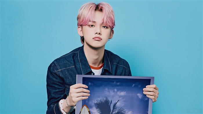 Yeonjun from TXT holding a framed picture