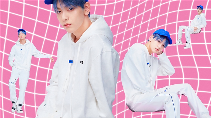 Soobin from TXT wearing white hoodie and blue cap