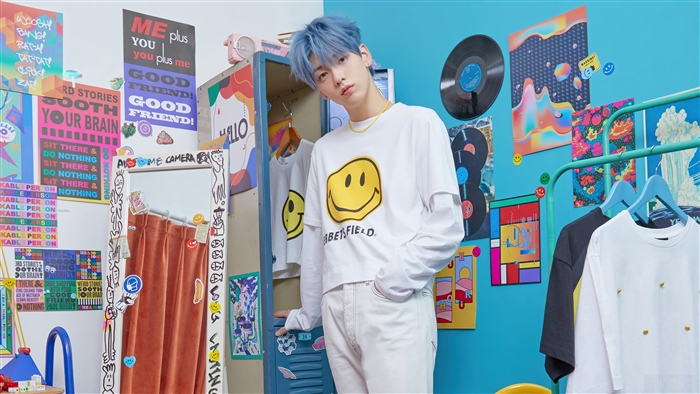 Soobin from TXT wearing a smiley face shirt