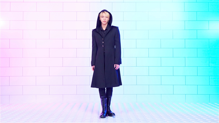 Taehyun from TXT wearing a black hooded coat