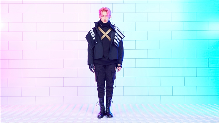 Yeonjun from TXT in a black outfit