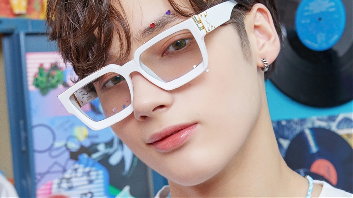 Huening Kai from TXT wearing white glasses