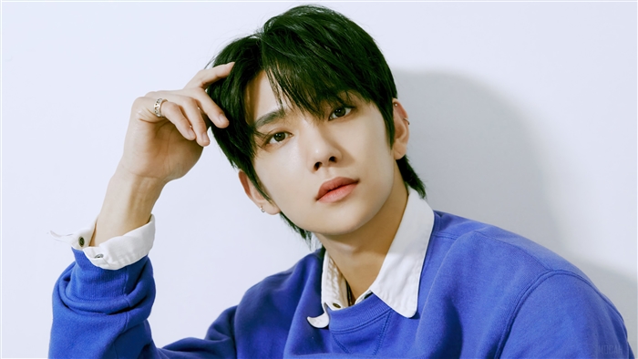 Joshua from Seventeen wearing a blue sweatshirt