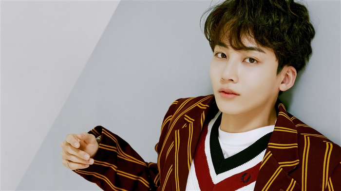Jeonghan from Seventeen wearing a striped jacket