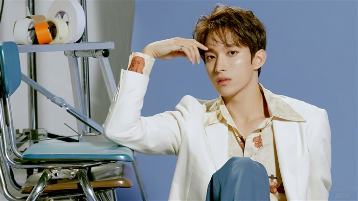 Dokyeom from Seventeen wearing a white suit