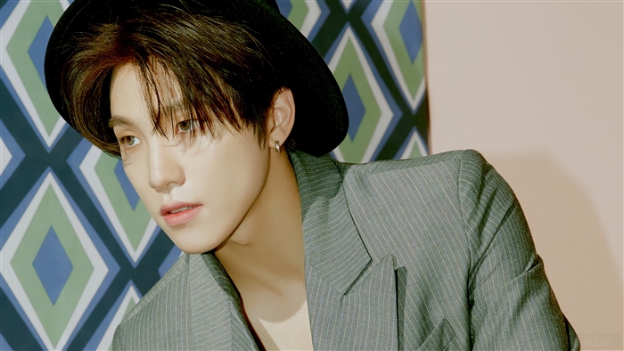 Dino from Seventeen wearing a hat and suit
