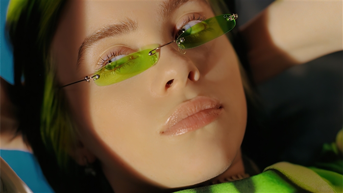 Billie Eilish with green hair and sunglasses