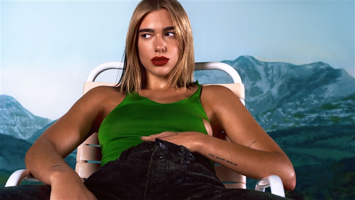 Dua Lipa in a green top and black pants