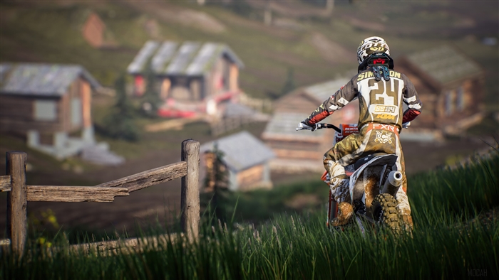 Motocross rider with number 24 in a village setting