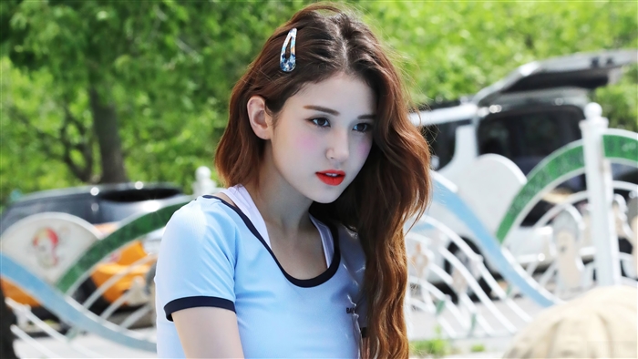 Jeon Somi in a blue top with a hair clip