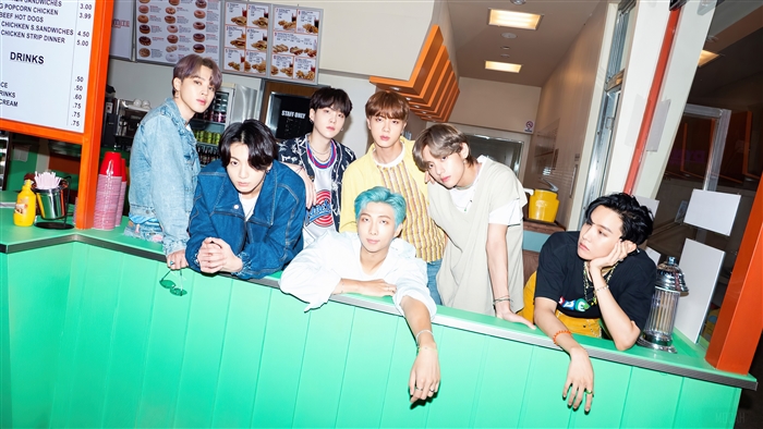 BTS Group Photo in Vibrant Retro Diner Setting