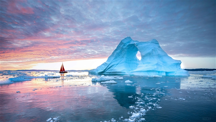 Sailboat near an iceberg at sunset 4K