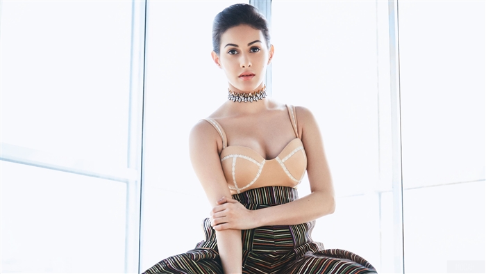 Amyra Dastur in a beige bustier and striped pants