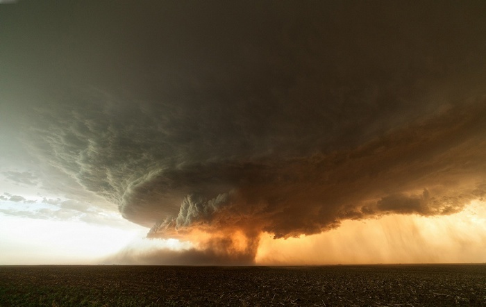 Dramatic Tornado and Storm Under Sunset Sky