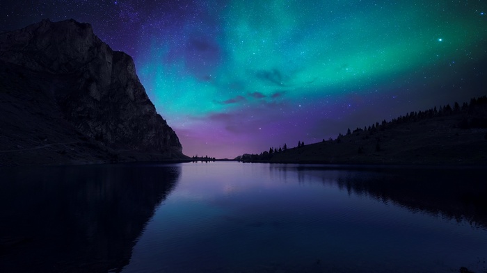Aurora Borealis over a mountain lake