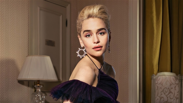Emilia Clarke in a purple dress with large earrings