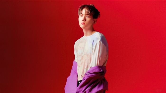 Baekhyun from K-pop in front of a red background