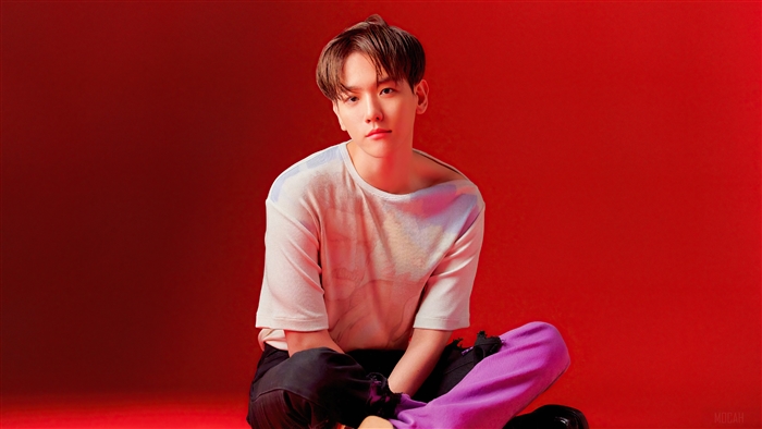 Baekhyun from K-pop sitting on red background