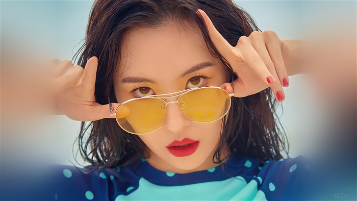 Sunmi wearing sunglasses and a blue swimsuit