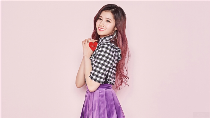 Sana from TWICE holding a red heart