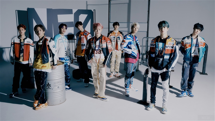 NCT 127 members in racing-inspired outfits