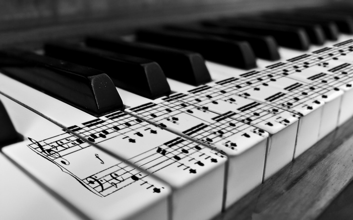 Monochrome piano keys with sheet music