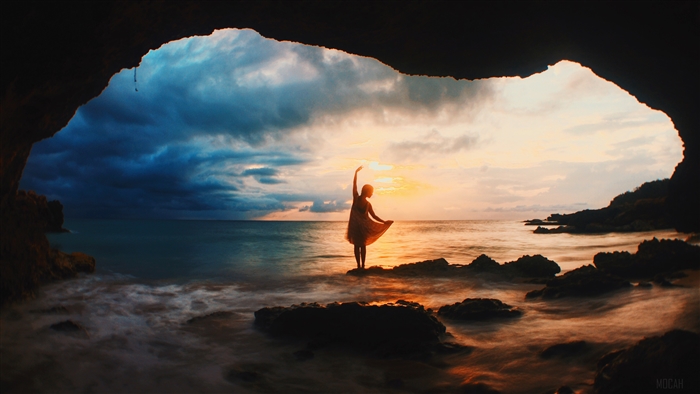 Silhouetted Figure at Sunset in Sea Cave 4K
