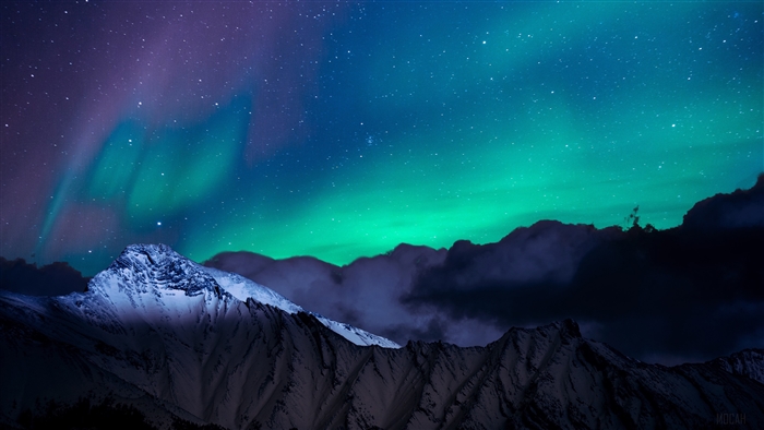 Aurora Borealis over Snowy Mountains at Night