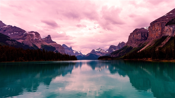 Turquoise lake and mountains with pink clouds 4K