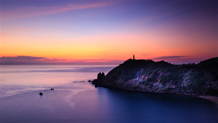 Sunset over the coast with a lighthouse