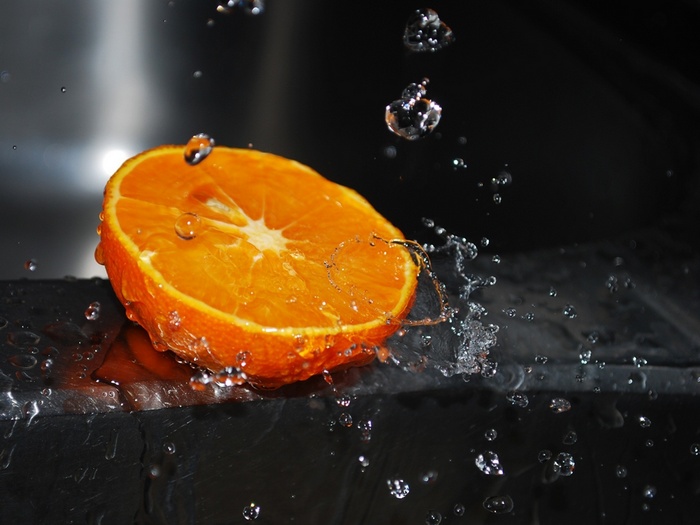 Orange slice with water drops and splashes