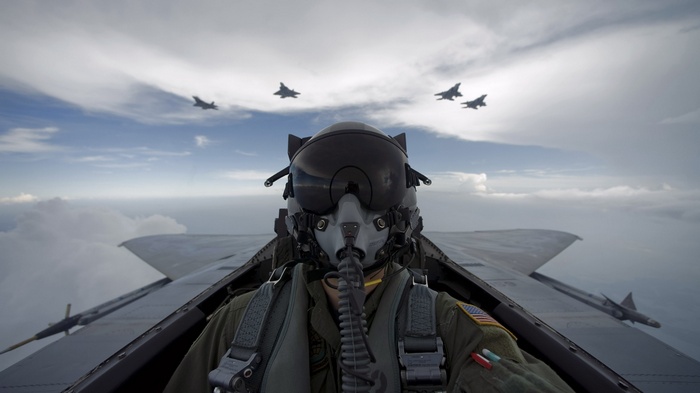 Pilot in fighter jet with other aircraft flying
