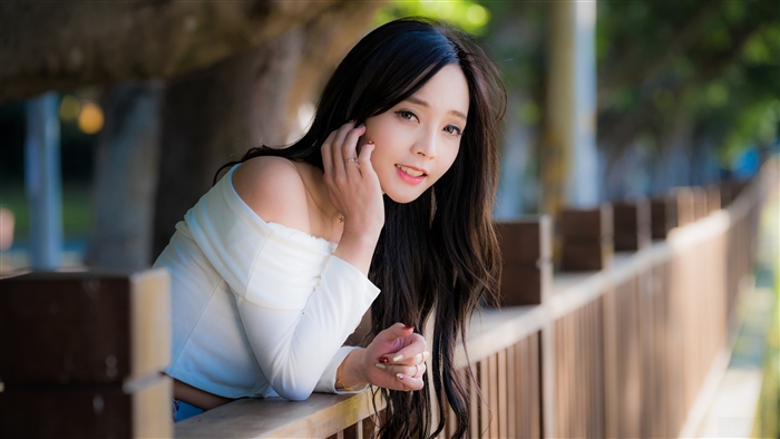 Smiling Woman with Long Brunette Hair in Nature