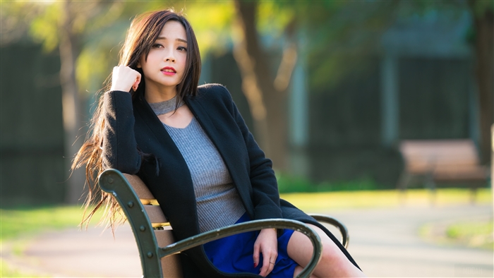 Thoughtful Woman in Black Coat on Bench